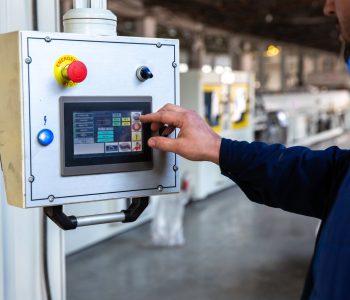 worker uses control panel in factory
